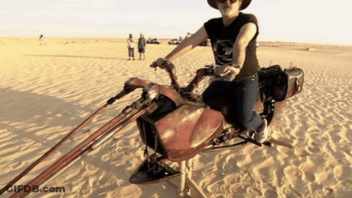 Man Riding Motorcycle In Desert GIF