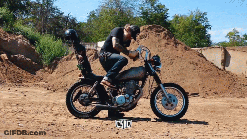 Man Riding Motorcycle In Dirt Field With Word Csnd GIF