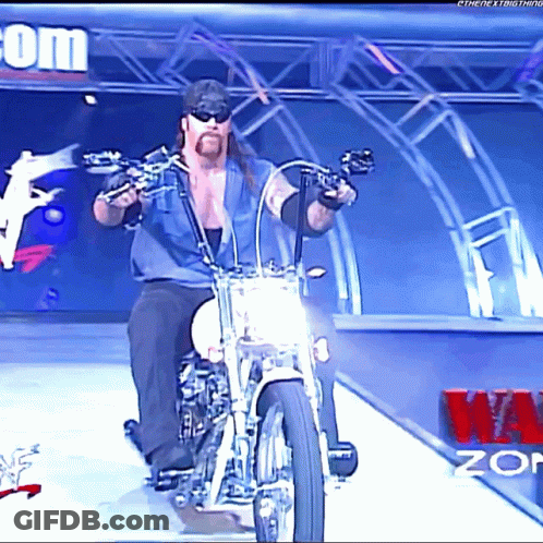 Man Riding Motorcycle In Front Of W.O.P Sign GIF