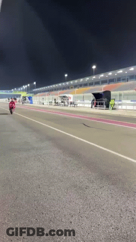 Man Riding Motorcycle On Race Track At Night GIF