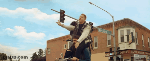 Man Riding On Shoulders In Front Of Scott Walker Sign GIF