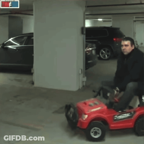 Man Riding Red Car With Tim Sid Sign GIF