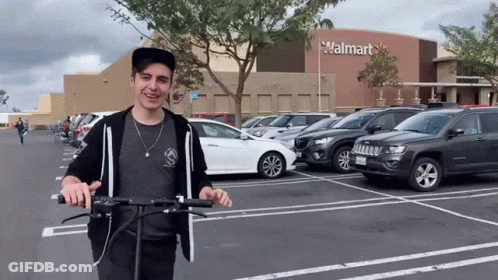 Man Riding Scooter In Front Of Walmart GIF