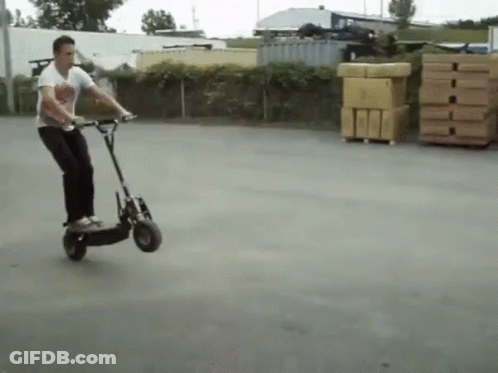 Man Riding Scooter In Parking Lot GIF