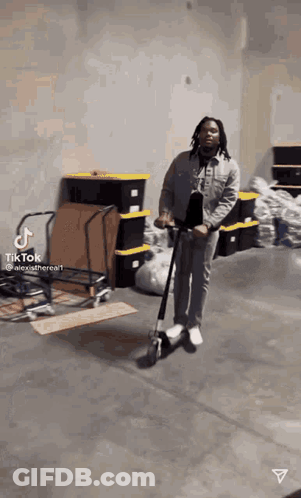 Man Riding Scooter In Warehouse GIF