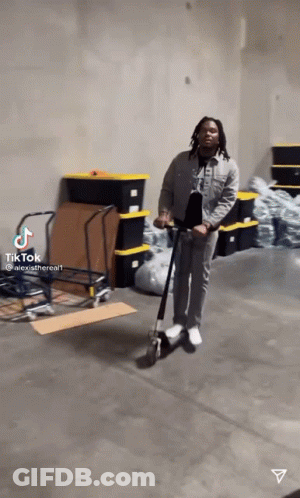 Man Riding Scooter In Warehouse GIF