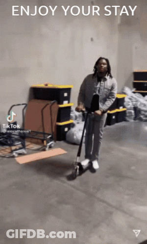 Man Riding Scooter In Warehouse GIF