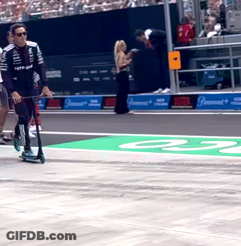 Man Riding Scooter On Race Track Number 23 GIF
