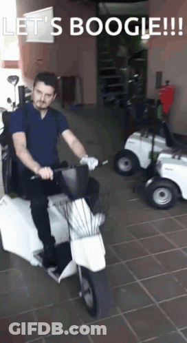 Man Riding Scooter Saying Let's Boogie GIF