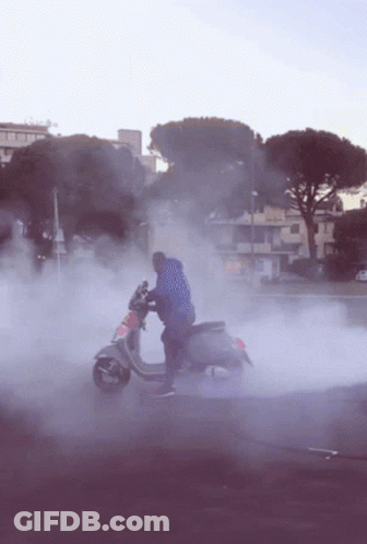 Man Riding Scooter With Smoke GIF