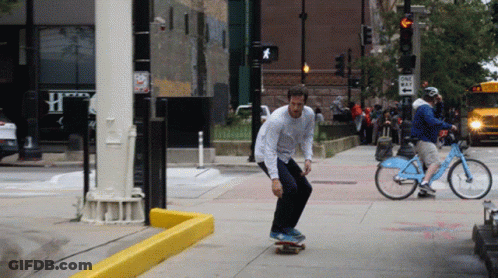 Man Riding Skateboard Near One Way Sign GIF