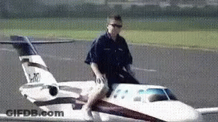 Man Riding Small Airplane Wing GIF