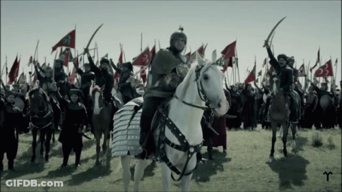 Man Riding White Horse Before Army GIF
