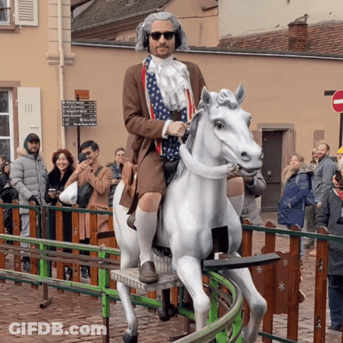Man Riding White Horse With College Of Agriculture Sign GIF