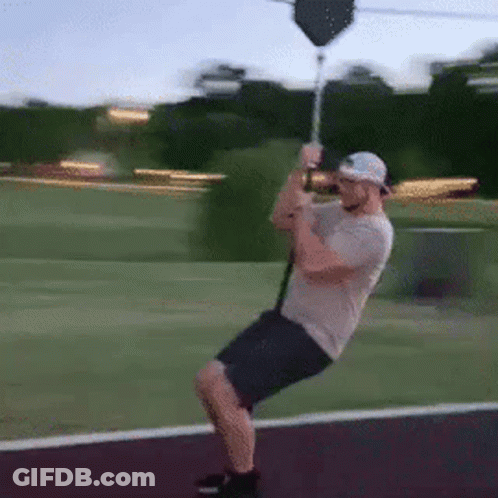 Man Riding Zip Line In Park GIF