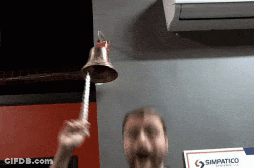 Man Ringing Bell In Front Of Simpatico Systems LLC Sign GIF