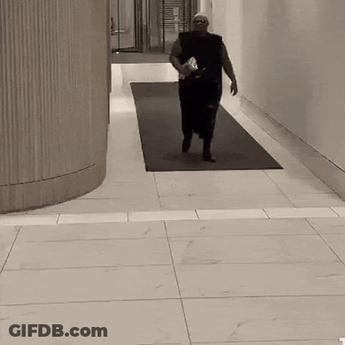 Man Running Down Hallway With Water Bottle GIF