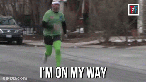 Man Running Down Street Saying Im On My Way GIF