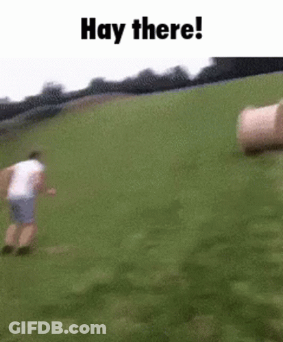 Man Running In Grassy Field With Hay Bales GIF