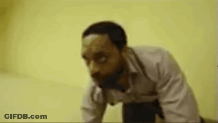 Man Running In Hallway With Picture Of Man And Letter T GIF