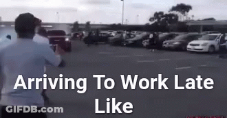 Man Running In Parking Lot Saying Arriving To Work Late GIF