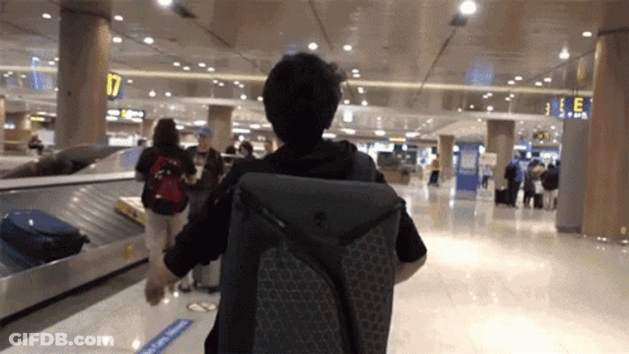 Man Running Inside Airport GIF