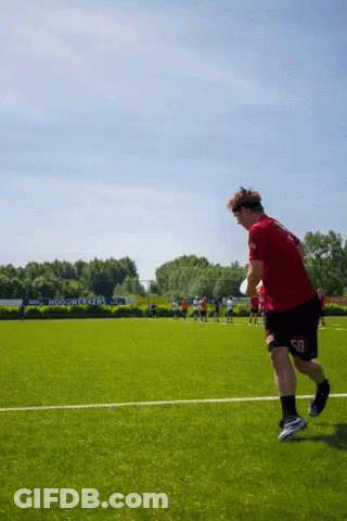 Man Running On Field In Red Shirt And Black Shorts GIF