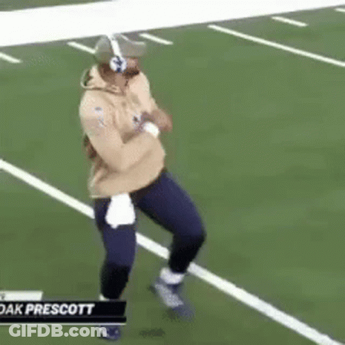 Man Running On Football Field With Headphones And Helmet GIF