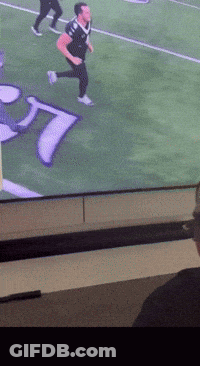 Man Running On Football Field With Letter T GIF