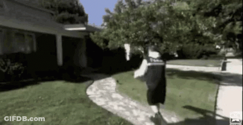 Man Running On Sidewalk Past House GIF