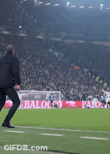 Man Running On Soccer Field Past Baloco Sign GIF