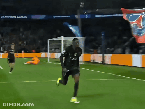 Man Running On Soccer Field With Champions League Banners GIF