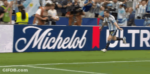 Man Running On Soccer Field With Michelob Ultra Banner GIF