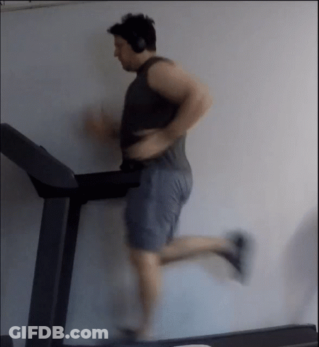 Man Running On Treadmill With Headphones GIF