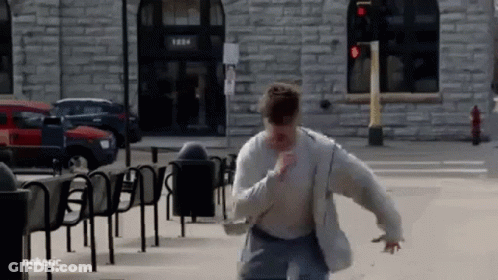 Man Running Past Brick Building 1284 GIF