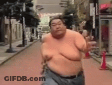 Man Running Shirtless Downtown GIF