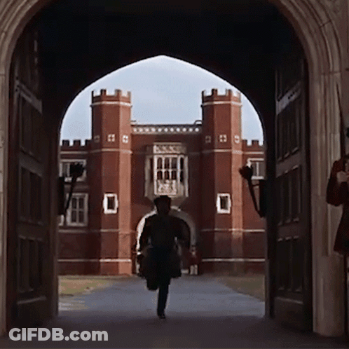 Man Running Through Archway At Brick Building GIF