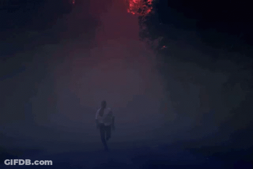 Man Running Through Foggy Forest At Night GIF