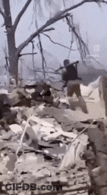 Man Running Through Rubble With Rifle GIF