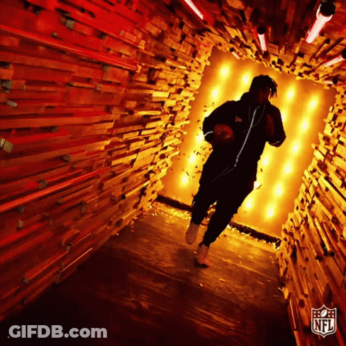 Man Running Through Wooden Tunnel With NFL Logo GIF