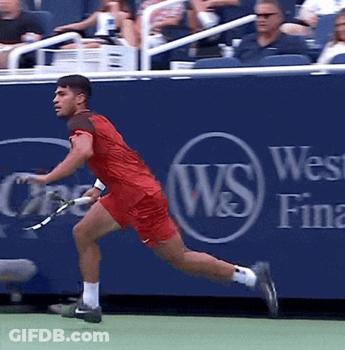 Man Running With Tennis Racquet By Blue Wall Saying W & S GIF