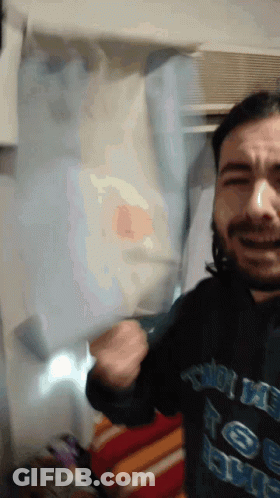 Man's Face Among Plants GIF