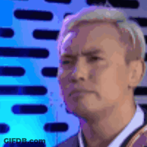 Man's Face Close Up Blue Background GIF