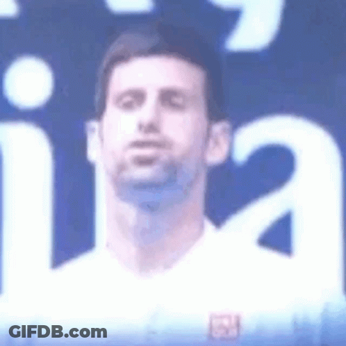 Man's Face Close Up Blue Background White Shirt GIF