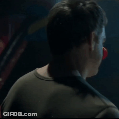 Man's Face Close Up In Dark Room GIF