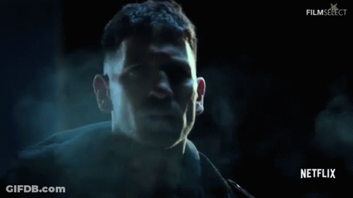 Man's Face Close Up In Dark Room GIF