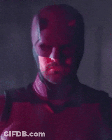 Man's Face Close Up In Red And Black Costume GIF