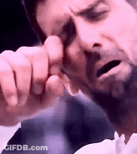 Man's Face Close Up On Pink Background GIF