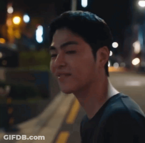 Man's Face Close Up On Sidewalk At Night GIF