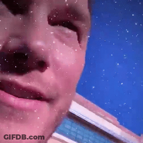 Man's Face Close Up With Falling Snow GIF